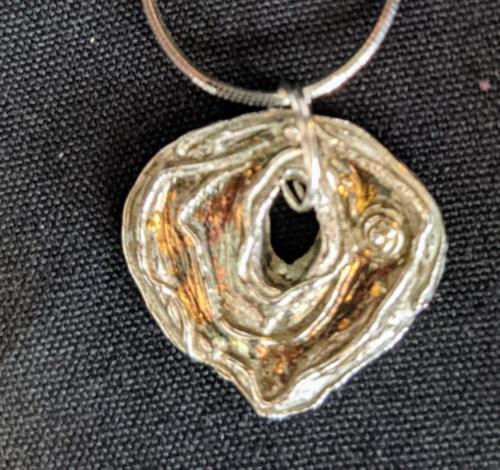 Silver pendant with patina